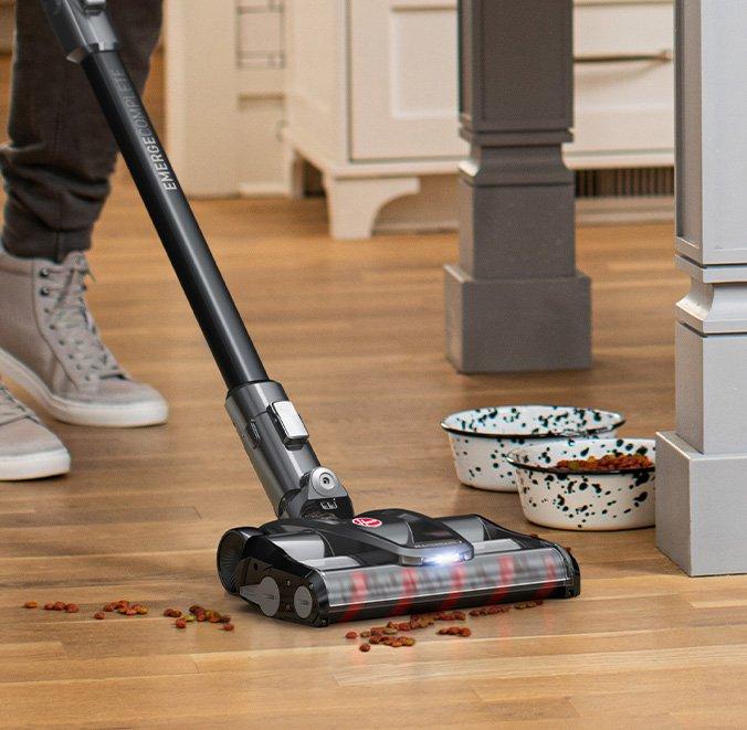 Hoover emerge vacuum cleaner is shown vacuuming spilled pet food efficiently.