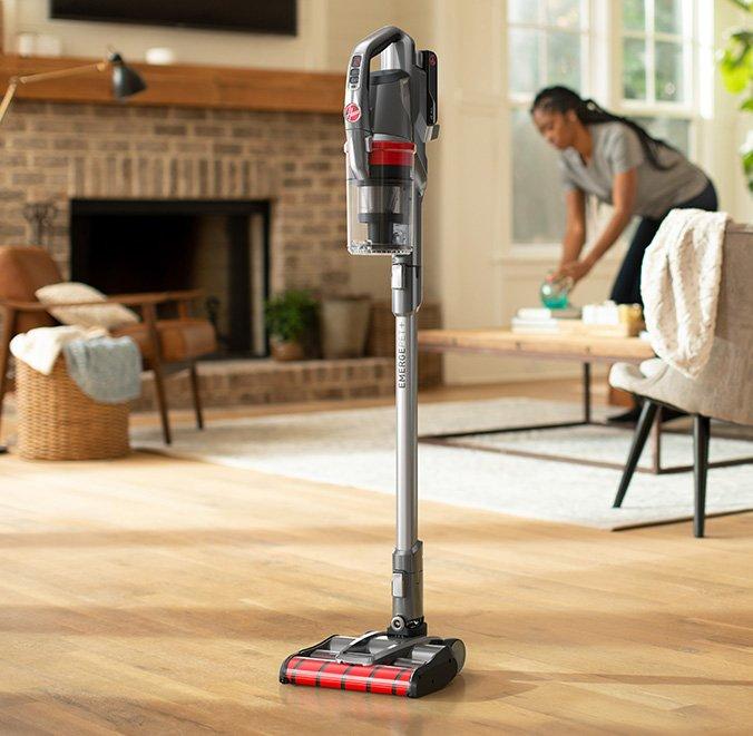 A hoover emerge pet self-standing vacuum cleaner standing upright on a hardwood floor in a living room, demonstrating its ease of use and convenience