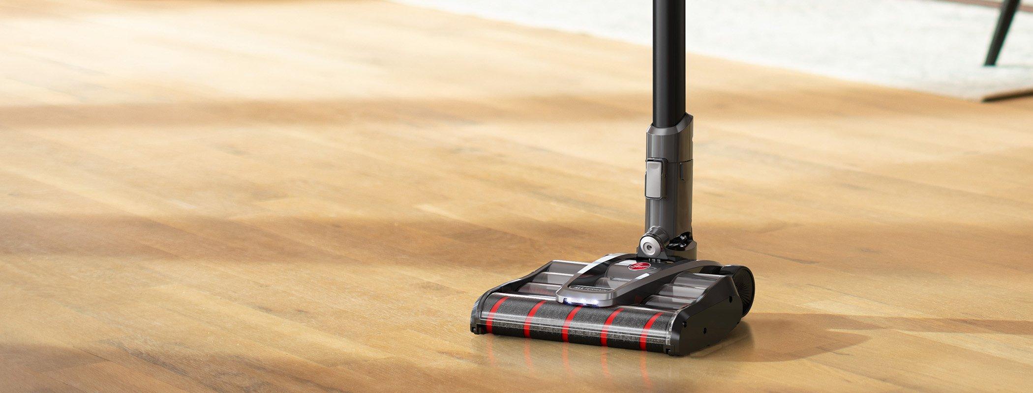 Hoover emerge complete vacuum in self standing mode on a wooden floor highlighting its sleek design and stability for cleaning convenience.