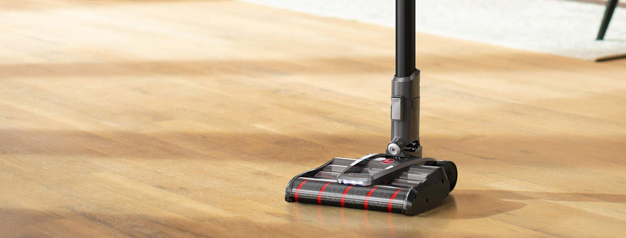 Hoover emerge complete vacuum in self standing mode on a wooden floor highlighting its sleek design and stability for cleaning convenience.