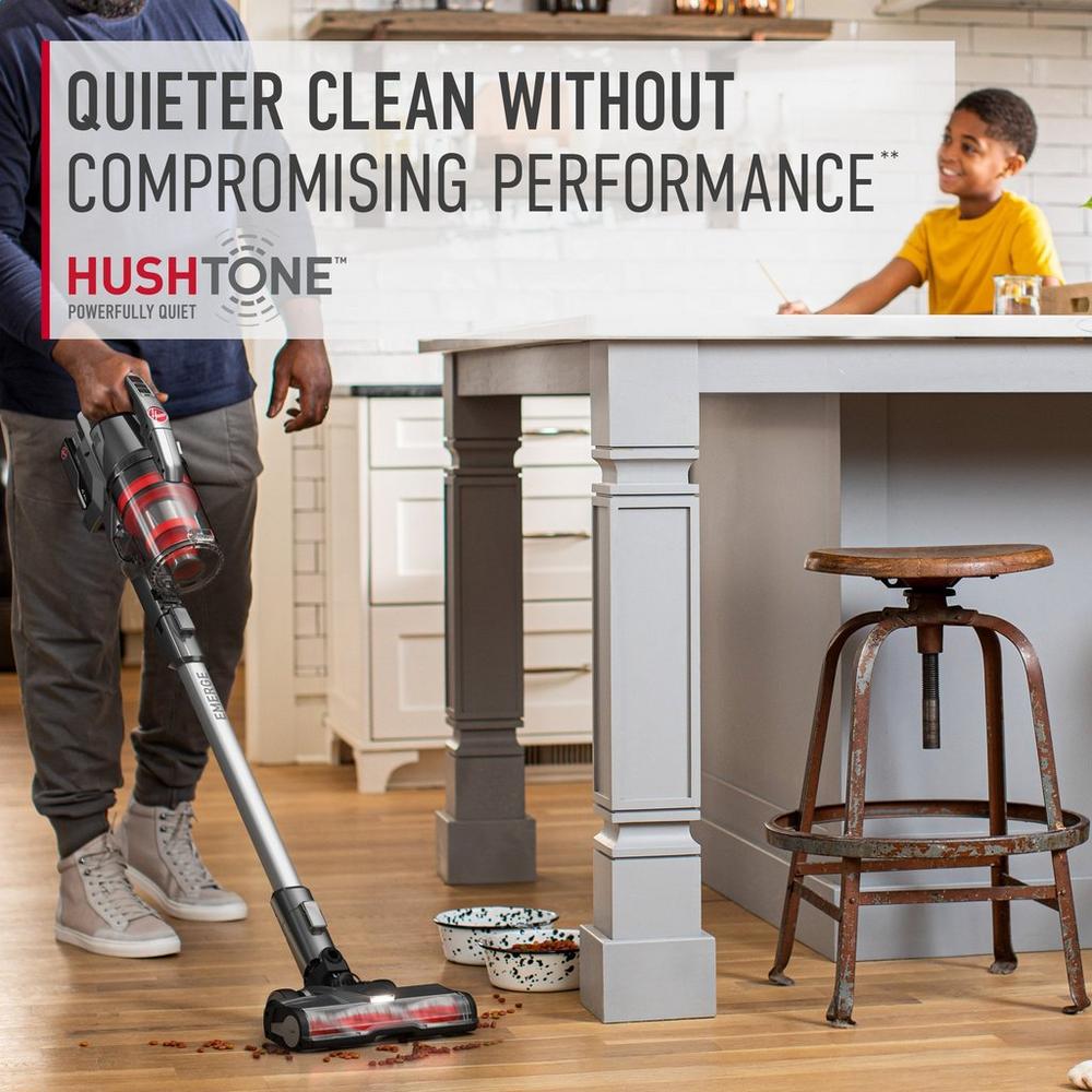 Man using his ONEPWR emerge cordless vacuum cleaner to vacuum spilled pet food in the kitchen as his child and dog watch. The text highlights its Hushtone feature which allows quieter clean without compromising performance.