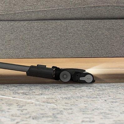 Cordless vacuum cleaner with low profile design for under furniture cleaning, ideal for maintaining cleanliness in all parts of the home, including tight spaces.  