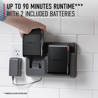 Close up of the Hoover ONEPWR battery system charging station mounted on a wall, with a hand inserting one of the two included batteries, offering up to 90 minutes runtime for the Hoover emerge cordless vacuum cleaner.