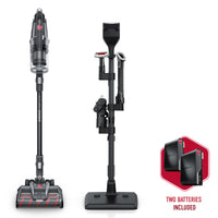 Hoover emerge pet cordless vacuum cleaner with all-terrain dual brush roll nozzle, shown alongside its accessory stand and two included batteries, emphasizing its versatility and extended runtime. 