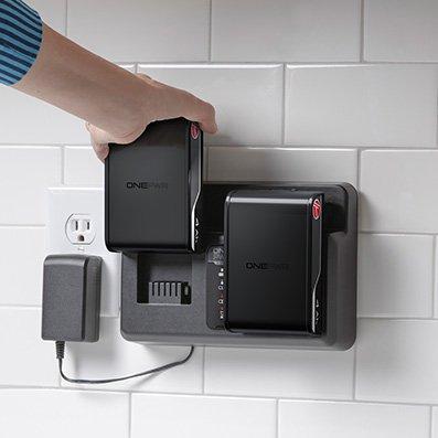 Person inserting their Hoover battery into the Hoover dual bay charger, which allows for longer cordless cleaning. 