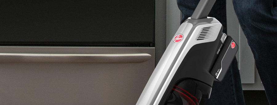 Side view of a Hoover cordless vacuum cleaner in use, featuring the 4Ah ONEPWR lithium-ion battery securely attached, emphasizing its portability and efficient design. 