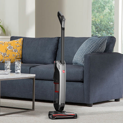 Hoover evolve pet elite self standing in the middle of a living room 