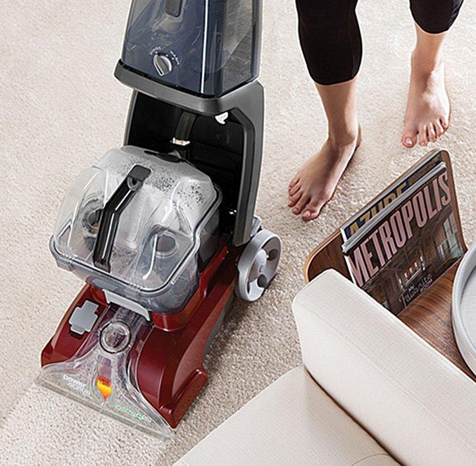 Top view of the Hoover power scrub carpet cleaner in action easily restoring a dirty carpet to its original white color