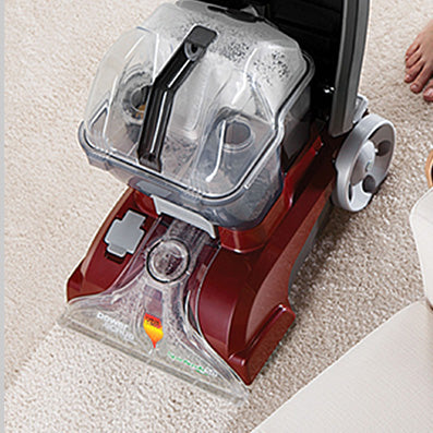 Top view of the Hoover power scrub carpet cleaner in action easily restoring a dirty carpet to its original white color