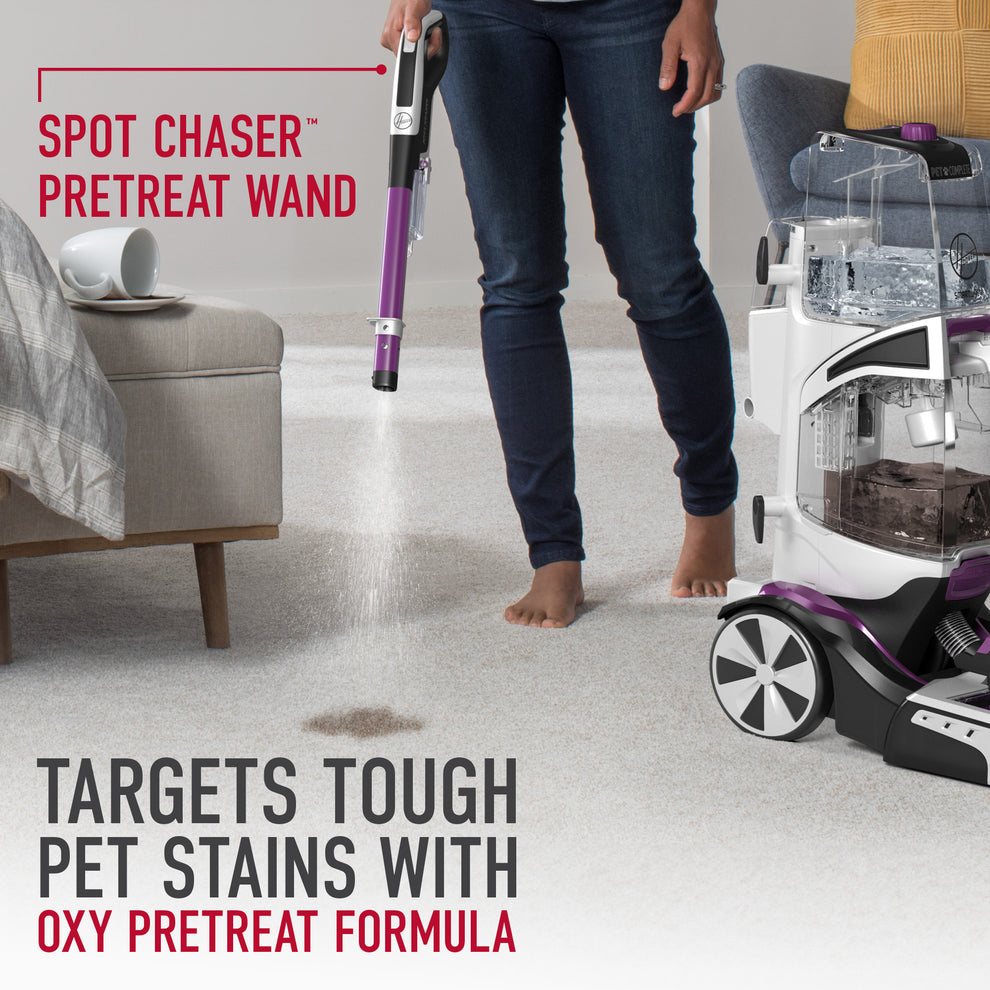 Someone using the included spot chaser pretreat wand to target tough pet stains with oxy pretreat formula