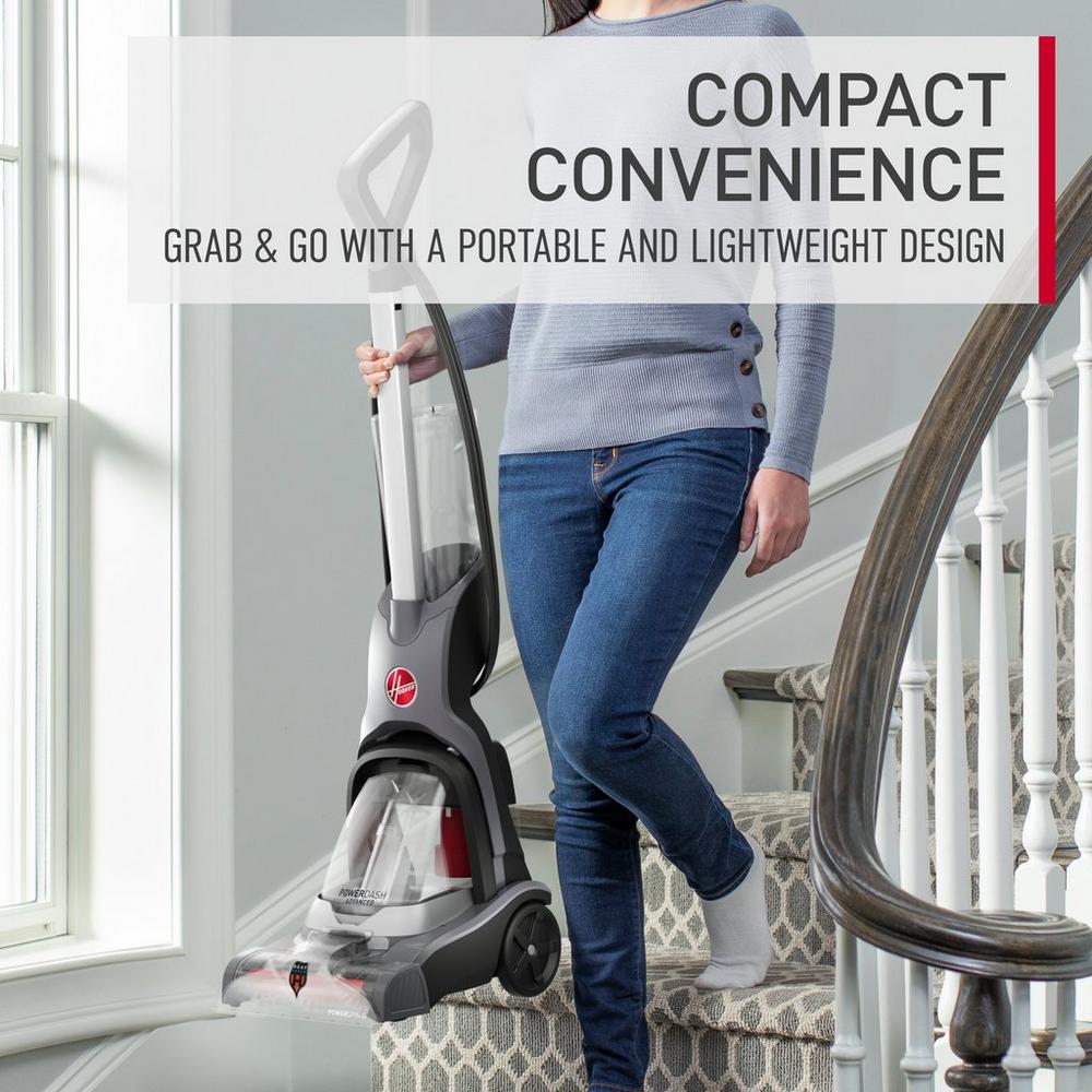 Woman easily carrying her powerdash pet advanced down the stairs showcasing its compact convenience.  She is able to grab and go since her powerdash pet advanced has a portable and lightweight design. 