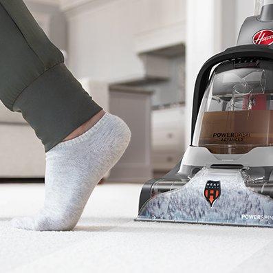 Someone is walking on carpet as its being cleaned with the powerdash pet advanced carpet cleaner, highlighting the heatforce technology, which allows for faster drying time.