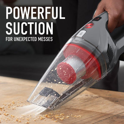 Hoover handheld vacuum cleaner is shown in action vacuuming crumbs, showcasing its powerful suction. 