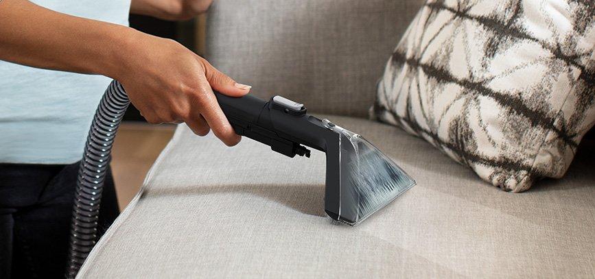 ONEPWR Cleanslate cordless portable spot cleaner with hoover upholstery tool is used to effectively clean a light colored couch