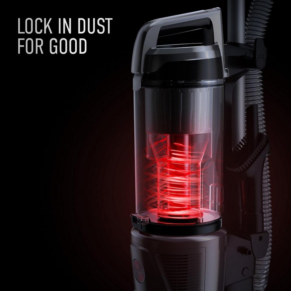 Close up of hoover vacuum cleaner dust bin with red cyclonic filtration system, featuring text "Lock in dust for good," highlighting dust containment technology 