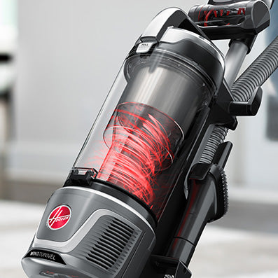 Close up of the dust container on a Hoover vacuum cleaner with red cyclone technology in action showcasing how effective it is in locking in dust for good